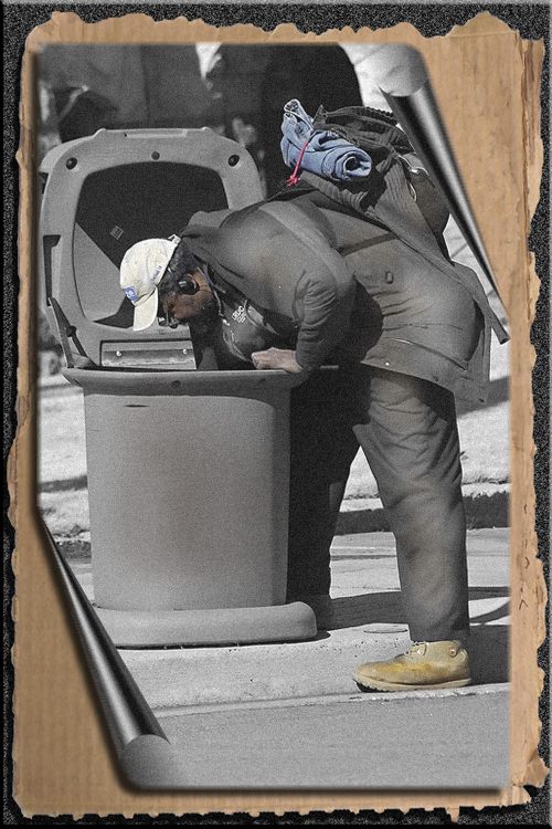 MAN LOOKING IN THE TRASH FOR A MEAL